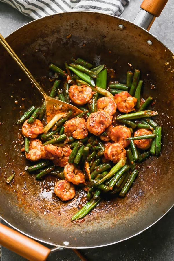 Stir-fry shrimp and green beans together with sauce. 