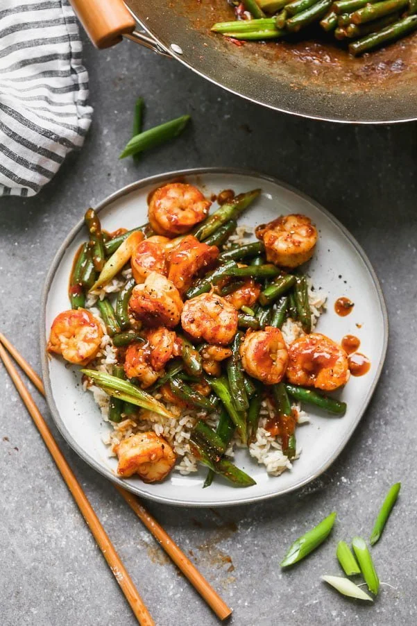 Hunan Shrimp is a hot and spicy shrimp dish packed with flavor from chili bean paste, garlic, soy sauce, and rice vinegar. The spicy plump shrimp are served with blistered green beans and green onions, and served over sticky brown rice. Ready in 20 minutes or less!&nbsp;