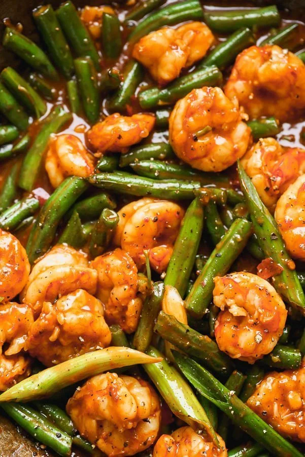 Hunan Shrimp is a hot and spicy shrimp dish packed with flavor from chili bean paste, garlic, soy sauce, and rice vinegar. The spicy plump shrimp are served with blistered green beans and green onions, and served over sticky brown rice. Ready in 20 minutes or less!&nbsp;