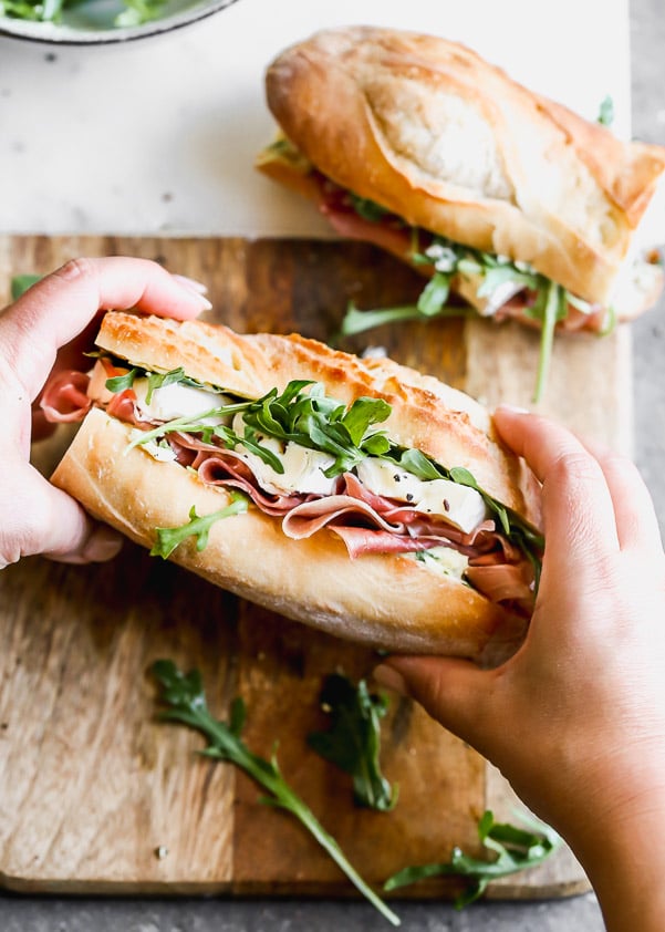 This classic French Baguette Sandwich, also known as a Jambon Beurre Sandwich is such a nice departure from a classic deli sandwich. Our version is layered on a crusty French baguette with salty prosciutto, an easy herbed butter, creamy brie, and peppery arugula. Effortlessly elegant, and most importantly, so delicious. 