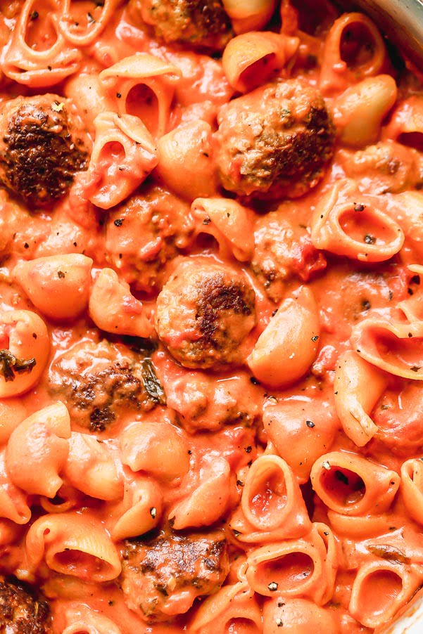 One Pot Creamy Tomato Pasta Sauce and Meatballs is spaghetti and meatballs meets vodka rigatoni, but it's all made neatly in one pot! Tender meatballs made with Italian sausage are seared until crusty and golden brown and then cooked with a creamy tomato sauce and adorable pipette shells. The perfect Sunday supper! 