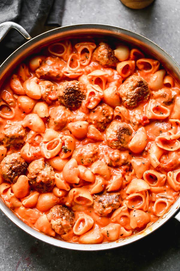 One Pot Creamy Tomato Pasta Sauce and Meatballs is spaghetti and meatballs meets vodka rigatoni, but it's all made neatly in one pot! Tender meatballs made with Italian sausage are seared until crusty and golden brown and then cooked with a creamy tomato sauce and adorable pipette shells. The perfect Sunday supper!&nbsp;