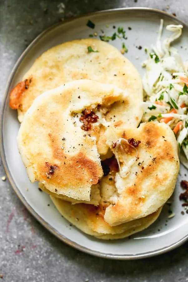 If you've never had Salvadoran Pupusas, you're in for a very delicious treat. Crispy corn flatbreads are stuffed with gooey oaxaca cheese and spicy chorizo, pan-fried until irresistibly crispy and then served with a simple slaw. Simple, but so delicious. 