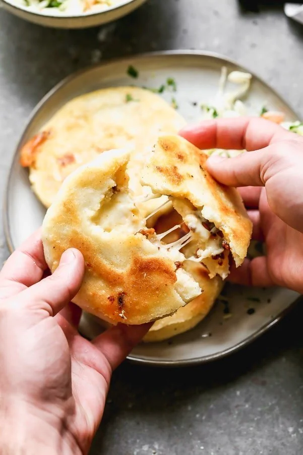 If you've never had Salvadoran Pupusas, you're in for a very delicious treat. Crispy corn flatbreads are stuffed with gooey oaxaca cheese and spicy chorizo, pan-fried until irresistibly crispy and then served with a simple slaw. Simple, but so delicious.&nbsp;