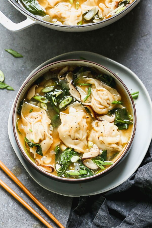 This Pork Wonton Soup is comforting, DELICIOUS, and just as good as any restaurant. We make homemade pork, scallion, and mushroom dumplings and then poach them in a simple soy sauce and sesame broth.