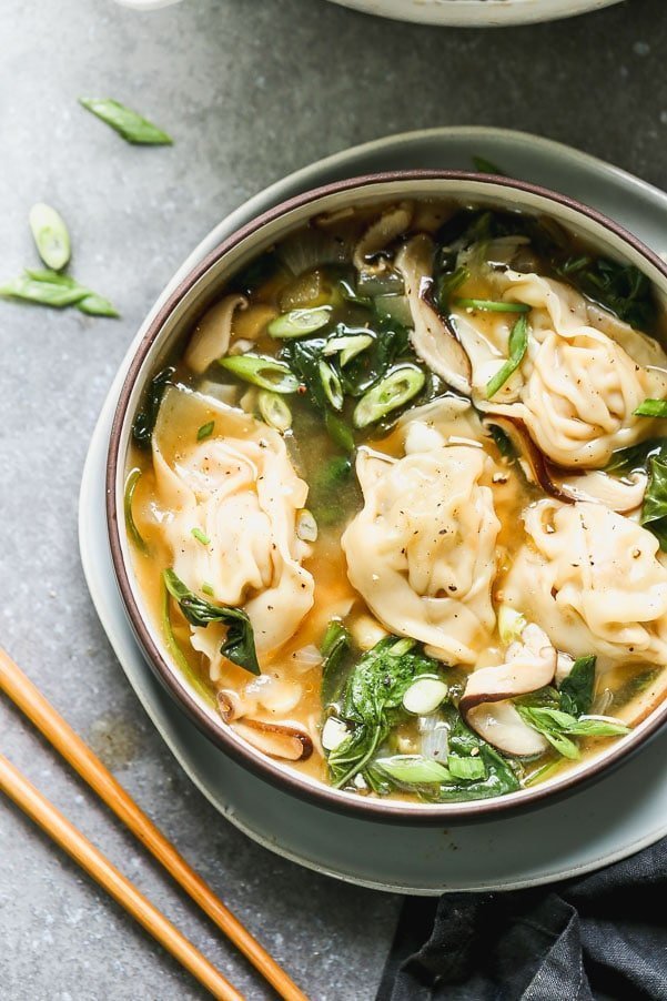 This Pork Wonton Soup is comforting, DELICIOUS, and just as good as any restaurant. We make homemade pork, scallion, and mushroom dumplings and then poach them in a simple soy sauce and sesame broth.