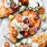 Crispy Chicken Cutlets are a cult-favorite in our family. We serve them all kinds of different ways, but our current favorite is serving them with a big dollop of creamy ricotta cheese and a zippy tomato and cucumber salad. 