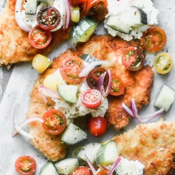 Crispy Chicken Cutlets are a cult-favorite in our family. We serve them all kinds of different ways, but our current favorite is serving them with a big dollop of creamy ricotta cheese and a zippy tomato and cucumber salad. 