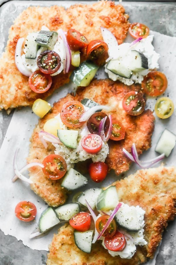 Crispy Chicken Cutlets are a cult-favorite in our family. We serve them all kinds of different ways, but our current favorite is serving them with a big dollop of creamy ricotta cheese and a zippy tomato and cucumber salad.&nbsp;