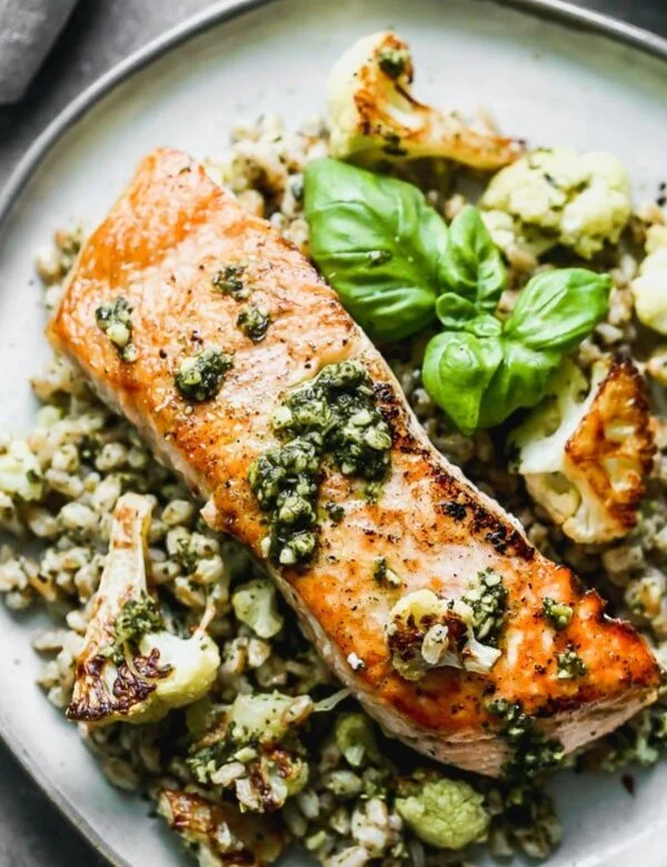  Salmon with Pesto and Roasted Cauliflower is an easy 5-ingredient full dinner! Yep, all you need is just five ingredients to create the crispiest, most flavorful salmon meal. We pan-sear salmon filets in a screaming hot cast iron skillet, and serve it over a bed of pesto farro studded with nutty roasted cauliflower. This is honestly the BEST five-ingredient meal you'll ever make!