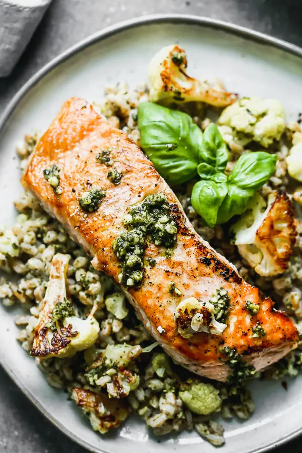 &nbsp;Salmon with Pesto and Roasted Cauliflower is an easy 5-ingredient full dinner! Yep, all you need is just five ingredients to create the crispiest, most flavorful salmon meal. We pan-sear salmon filets in a screaming hot cast iron skillet, and serve it over a bed of pesto farro studded with nutty roasted cauliflower. This is honestly the BEST five-ingredient meal you'll ever make!