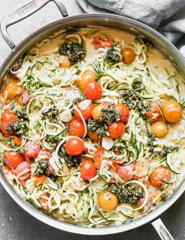 Our Zucchini Noodles with Burst Cherry Tomato Sauce and Pesto is a great way to get your pasta fix without all the calories. We toss zucchini noodles and a little bit of whole-wheat spaghetti with sweet blistered cherry tomatoes, creamy ricotta, and a touch of parmesan cheese. We finish it off with a drizzle of pesto and serve! 