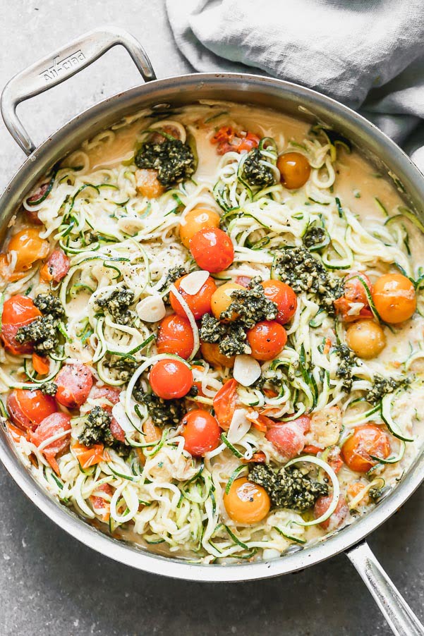 Our Zucchini Noodles with Burst Cherry Tomato Sauce and Pesto is a great way to get your pasta fix without all the calories. We toss zucchini noodles and a little bit of whole-wheat spaghetti with sweet blistered cherry tomatoes, creamy ricotta, and a touch of parmesan cheese. We finish it off with a drizzle of pesto and serve!&nbsp;