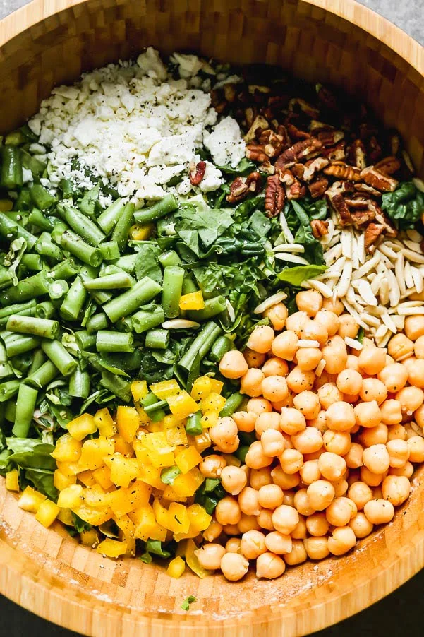 Chopped salad with pecans, feta, green beans, chickpeas, yellow peppers, and almonds
