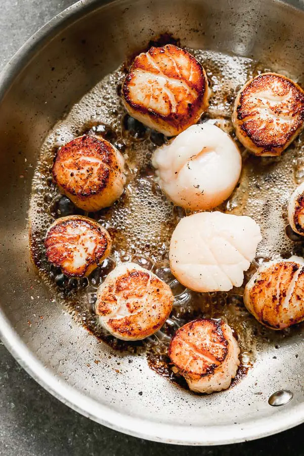 Flip scallops when they have a golden brown crust on the bottom. 