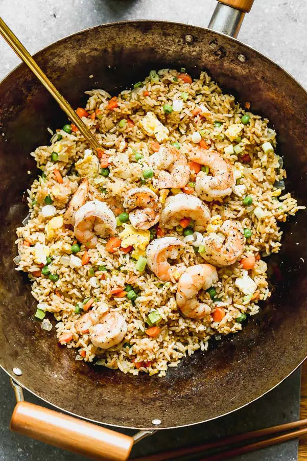 The BEST Shrimp Fried Rice with peas, carrots, and lots of scrambled eggs. Perfect way to use up leftover rice!