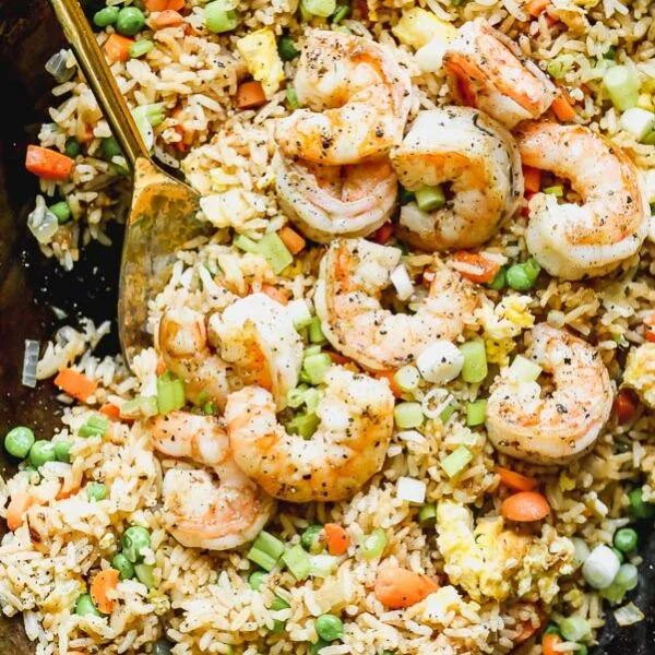 Our Easy Shrimp Fried Rice is our favorite way to use up leftover steamed white rice. We stir-fry cold rice with plenty of carrot, onion, and garlic, and then toss it with egg, frozen peas, green onion, and of course lots of soy sauce and sesame oil. Swap out your favorite protein for the shrimp or add a variety for a hearty meal.
