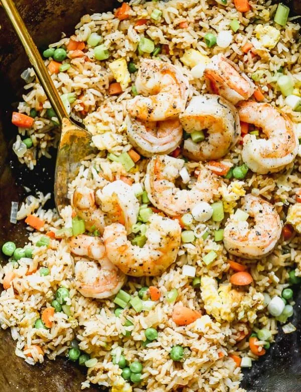 Our Easy Shrimp Fried Rice is our favorite way to use up leftover steamed white rice. We stir-fry cold rice with plenty of carrot, onion, and garlic, and then toss it with egg, frozen peas, green onion, and of course lots of soy sauce and sesame oil. Swap out your favorite protein for the shrimp or add a variety for a hearty meal.