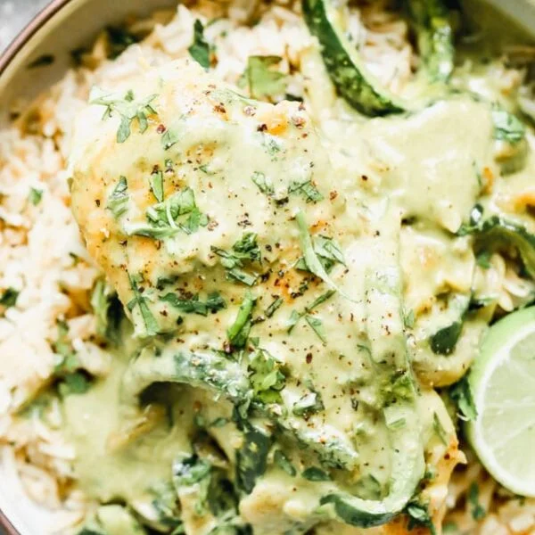 If you guys are sick of average chicken dinner after average chicken dinner, let me introduce you to our new best friend: Creamy Poblano Chicken with Cilantro Rice Pilaf. We sear chicken breasts in a little bit of butter, then simmer them in a ridiculously delicious poblano cream sauce studded with caramelized onions and sliced poblano peppers. The dish is perfect on its own, but to make sure we get every last drop of that poblano cream sauce, we serve the chicken on top of an easy rice pilaf sure to become a new staple in your side dish repertoire.