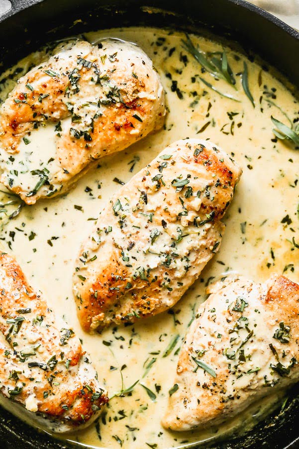 Our Creamy Tarragon Chicken is a great easy weeknight dinner that feels elevated. We sear chicken breasts in a cast-iron skillet and then simmer them in a creamy, garlicky tarragon and mustard sauce. Serve with veggies, pasta, or a little bit of creamy mashed potatoes.
