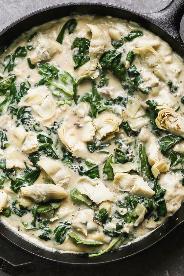 Pour eggs over spinach and artichokes. 