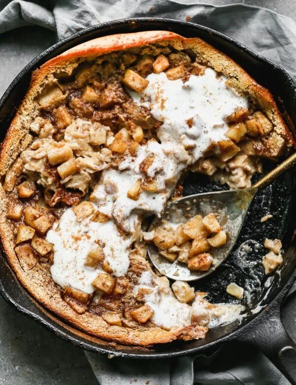Our Caramel Apple Clafoutis Recipe is one of the easiest most impressive desserts you'll make all fall long. This pancake meets souffle baked dessert is studded with brown butter caramel apples, plenty of warm fall spices and baked until brown on the outside and soft and custard-like on the inside. Oh, and it's a cinch to throw together. 