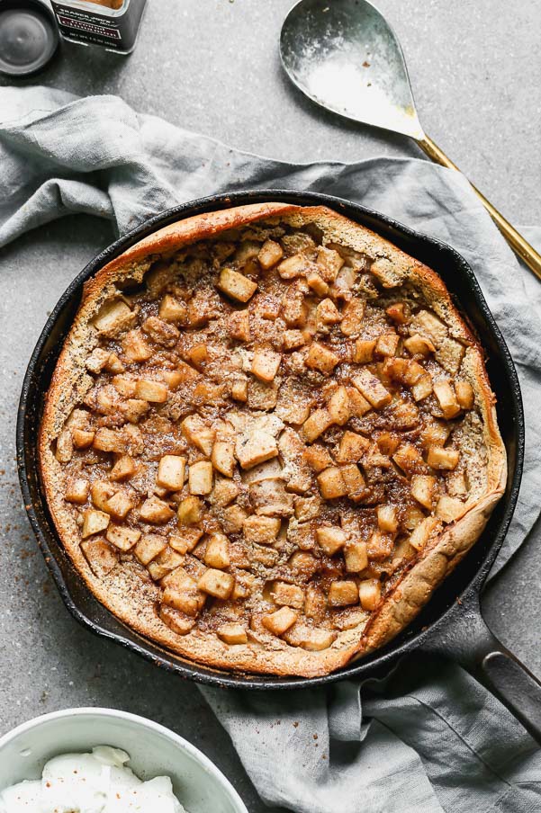 Our Caramel Apple Clafoutis Recipe is one of the easiest most impressive desserts you’ll make all fall long. This pancake meets soufflé baked dessert is studded with brown butter caramel apples, plenty of warm fall spices and baked until brown on the outside and soft and custard-like on the inside. Oh, and it’s a cinch to throw together. 