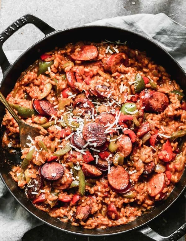 Spicy Cajun food meets creamy cheesy Italian food in our Cheesy Cajun Sausage Risotto. This one-pot wonder has everything you need in a hearty dinner - creamy arborio rice, plenty of veggies, spicy andouille sausage, and a cheese factor you'll fall in love with. 