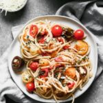 Spicy Bucatini Recipe: We cook cherry tomatoes and spicy fresno chilies in butty brown butter, and then toss it with chewy bucatini noodles, toasted almonds, fresh thyme, and plenty of garlic. A little bit of salty, starchy pasta water and parmesan cheese finish off this irresistibly spicy, nutty summer to fall pasta. 