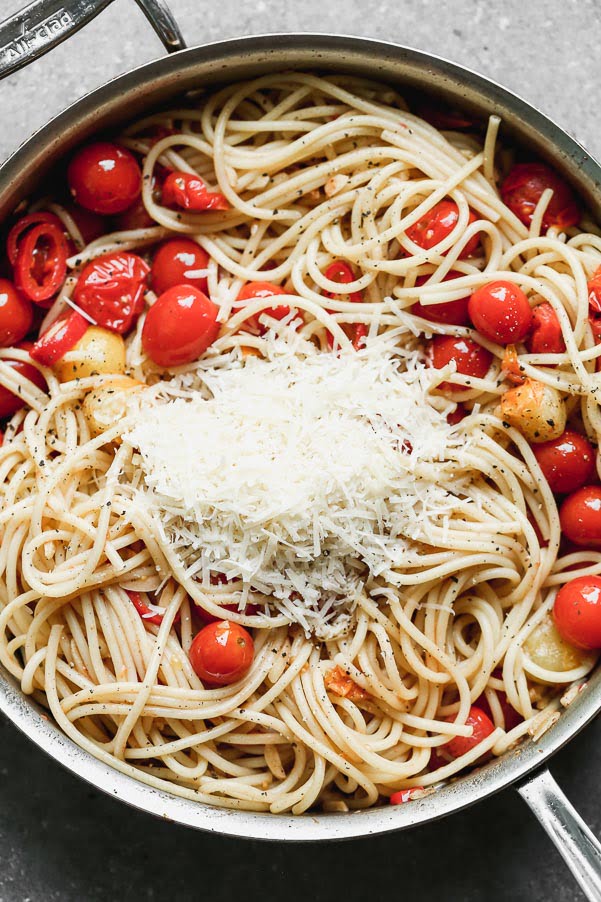 Toss bucatini, tomatoes, and chilies with pasta water and parmesan cheese, 