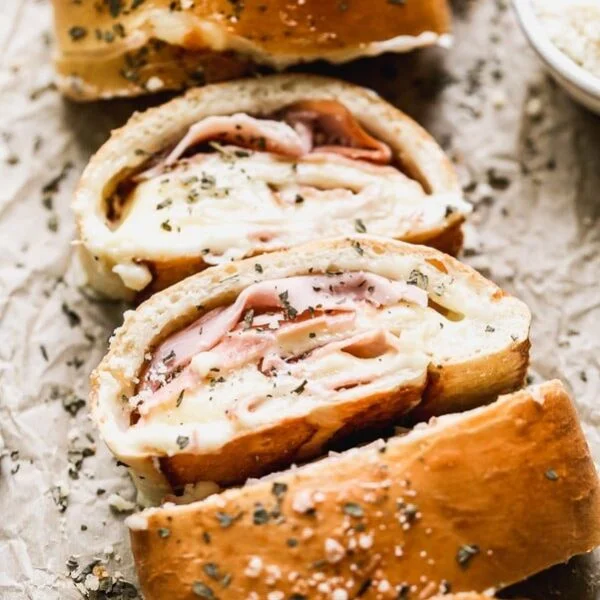 With just five ingredients, you can whip up our favorite easy lunch: Ham and Cheese Stromboli. We take frozen bread or pizza dough, layer it up with salty ham, gooey white American cheese, and then roll it up and bake. Simplicity at its finest, and oh-so cheesy.