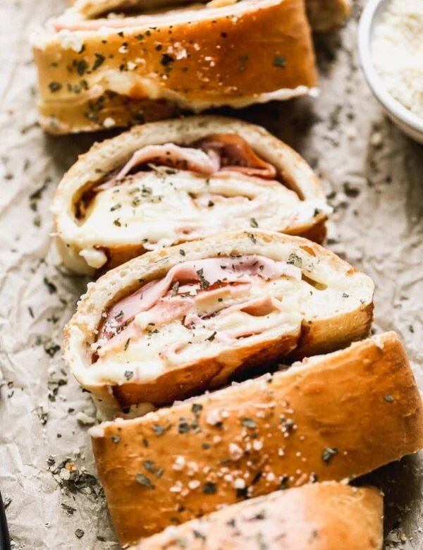 With just five ingredients, you can whip up our favorite easy lunch: Ham and Cheese Stromboli. We take frozen bread or pizza dough, layer it up with salty ham, gooey white American cheese, and then roll it up and bake. Simplicity at its finest, and oh-so cheesy.