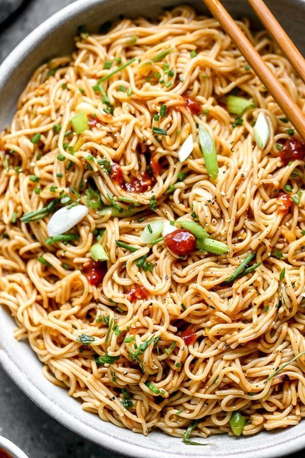 Our Chili Garlic Noodles use only five simple ingredients and bring dinner to your table in 20 minutes or less. We stir-fry brown rice ramen noodles with chili paste, LOTS of garlic, soy sauce, and plenty of scallions. What results is a simple Asian noodle packed with spice and flavor.
