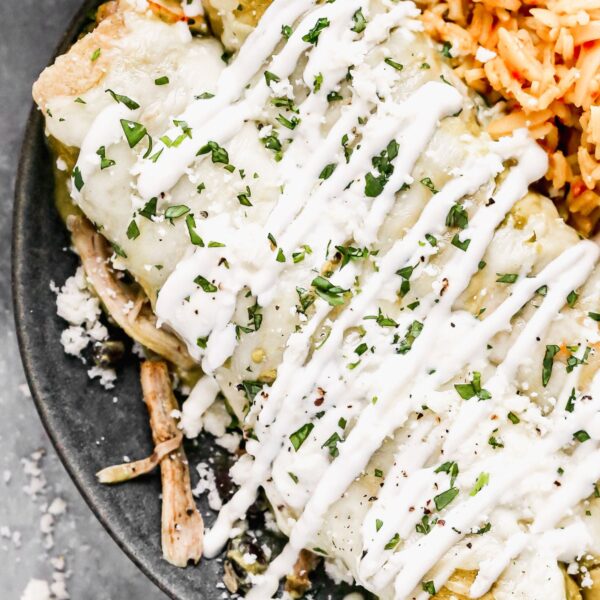 Bathed in homemade roasted salsa verde, stuffed with smoky shredded chicken and black beans, and smothered in melty monterrey jack cheese, these Enchiladas Verdes really hit the tex-mex spot. By roasting everything on one pan, these made-from-scratch enchiladas come together with a little bit less effort than your average homemade enchilada recipe. And do I even need to address how delicious they are?? So so good. 