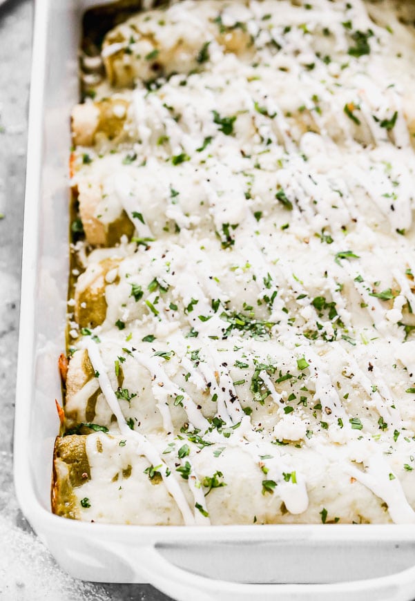 Bathed in homemade roasted salsa verde, stuffed with smoky shredded chicken and black beans, and smothered in melty monterrey jack cheese, these Enchiladas Verdes really hit the tex-mex spot. By roasting everything on one pan, these made-from-scratch enchiladas come together with a little bit less effort than your average homemade enchilada recipe. And do I even need to address how delicious they are?? So so good. 