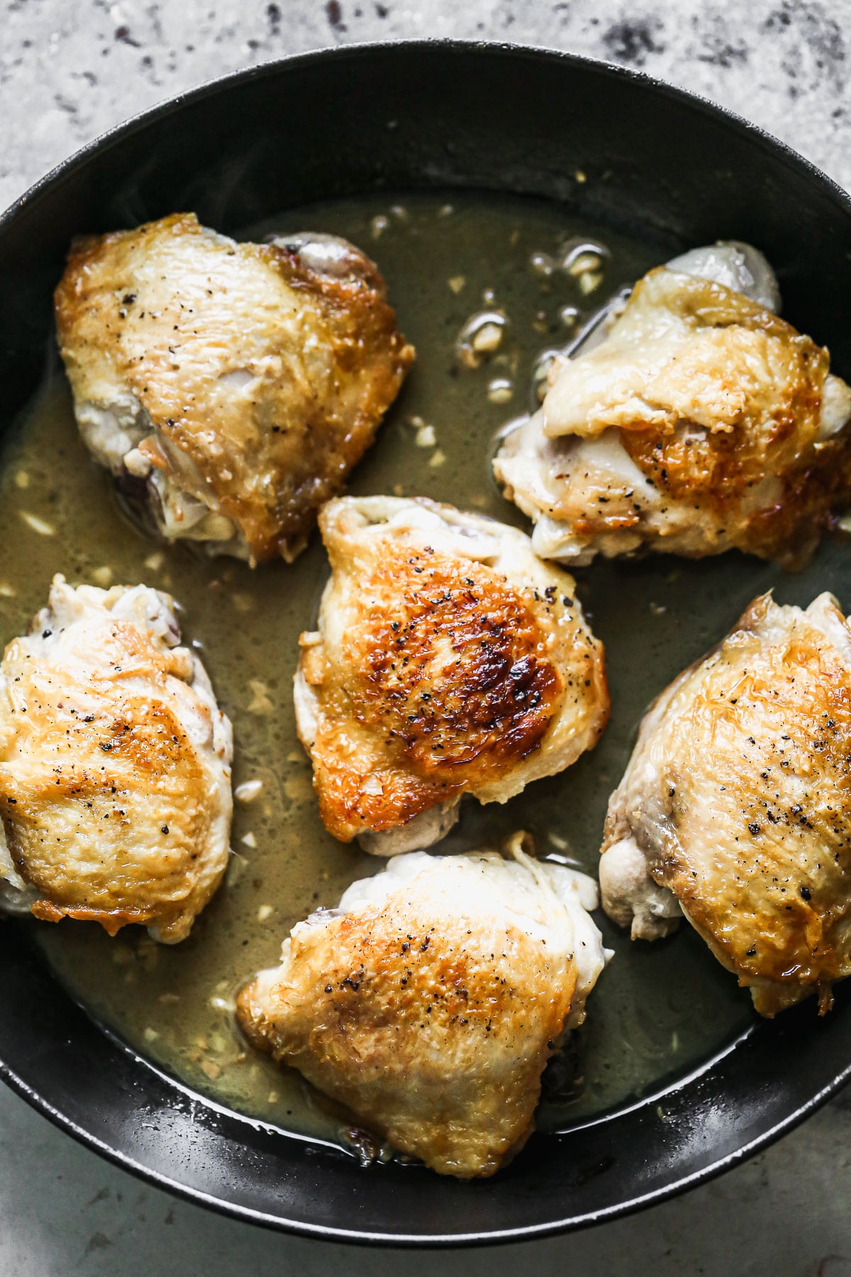 Chicken thighs simmering in honey lime sauce