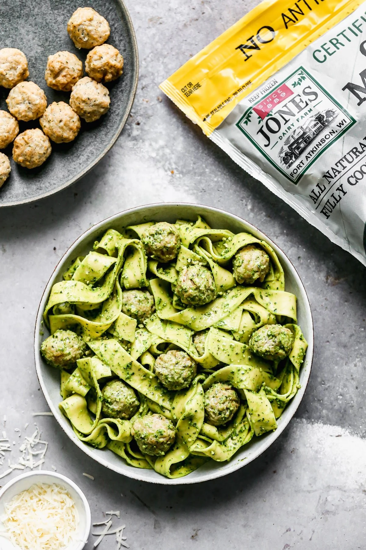 Twirly noodles tossed in a five-minute kale pesto, tender chicken meatballs, and plenty of nutty parmesan are the makings of our new favorite throw-it-together weeknight meal – Kale Pesto Pasta. Just because it's winter, doesn't mean we have to leave homemade pesto behind. Swapping out hearty wintery kale for a portion of the pesto brings a little seasonal aspect to our pesto and using crunchy almonds instead of pine nuts make this easy meal pocket-friendly as well.&nbsp;