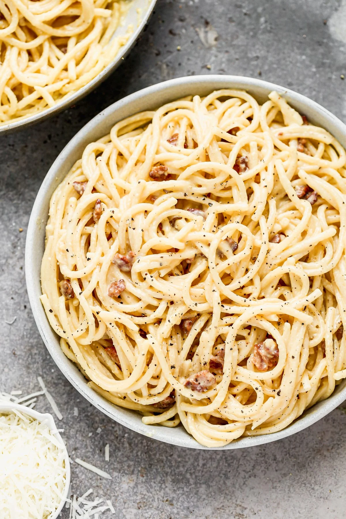 Silky-smooth noodles twirled in a rich, creamy (but cream-less) sauce, nutty pecorino cheese, and bits of salty bacon, our Bucatini Carbonara is the ultimate in Italian comfort food and arguably, the simplest. &nbsp;Our version amps up the amount of both cheese and bacon, adds in a little bit of garlic, and swaps out classic spaghetti for thick bucatini noodles.