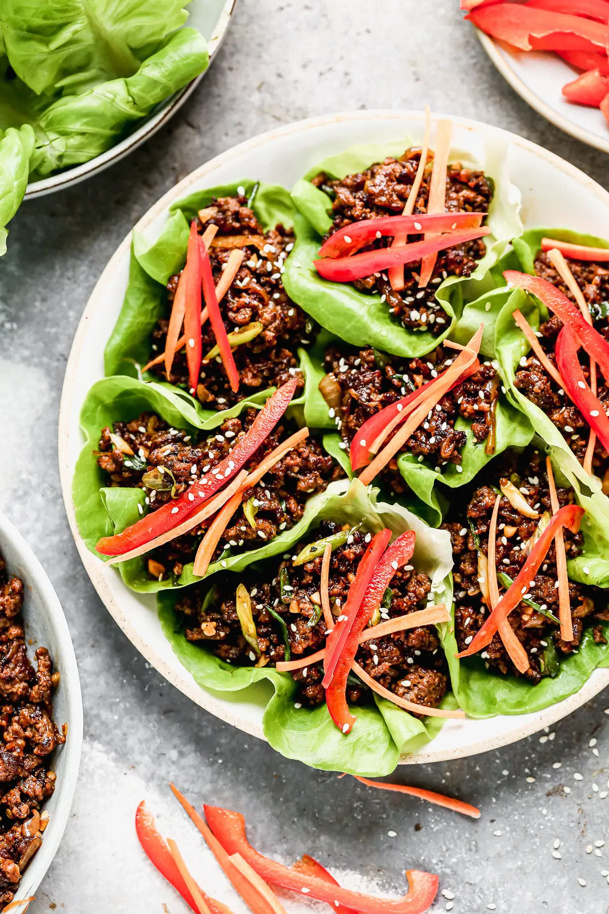 Ultra crispy and smothered in a soy-based sauce studded with rich brown sugar, sweet mirin wine, and brimming with heat from Sambal Oelek, these Beef Lettuce Wraps are my new favorite way to do lettuce. With easy-to-find ingredients, and minimal prep and cook time, they're also the perfect way to get dinner on the table without  much effort. 