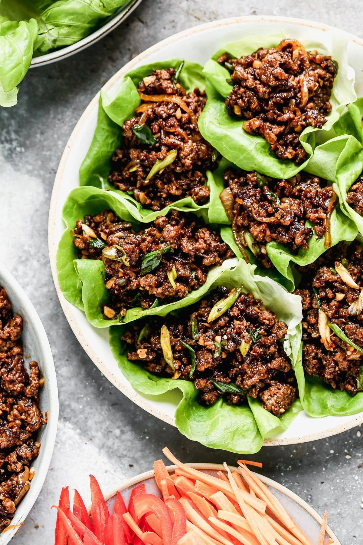 Ultra crispy and smothered in a soy-based sauce studded with rich brown sugar, sweet mirin wine, and brimming with heat from Sambal Oelek, these Beef Lettuce Wraps are my new favorite way to do lettuce. With easy-to-find ingredients, and minimal prep and cook time, they're also the perfect way to get dinner on the table without  much effort. 