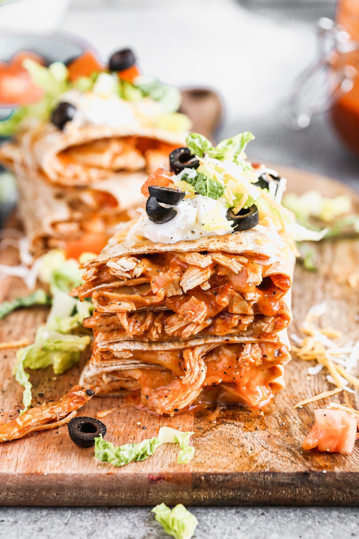 Chicken enchilada on the inside, taco on the outside is what makes our Chicken Enchilada Taco Quesadillas the perfect handheld hybrid of three classic tex-mex dishes. Each whole-wheat tortilla is filled with saucy shredded chicken (made with our epic homemade enchilada sauce) and cheese, pan-fried and then smothered with all your favorite taco fixings! 