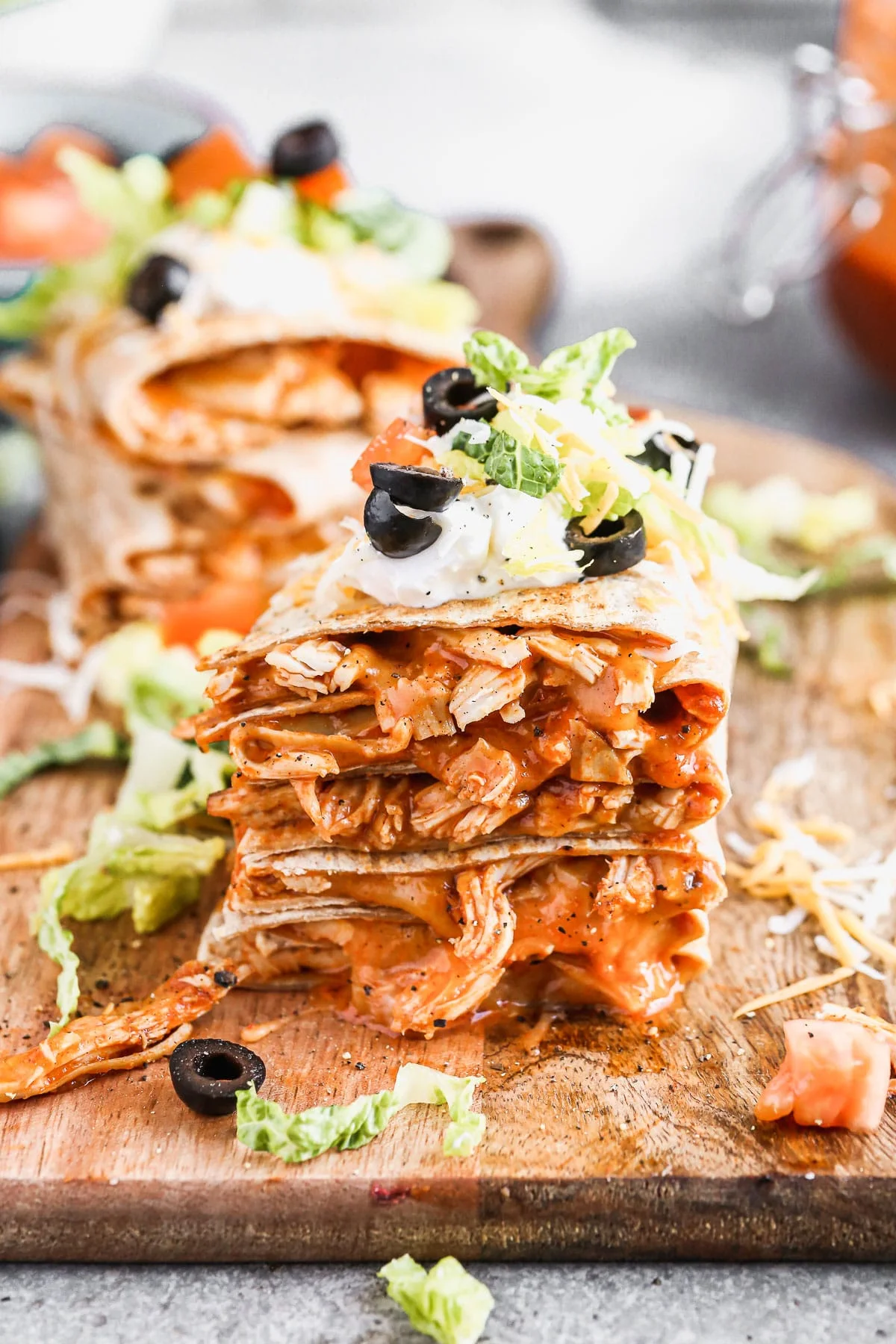 Chicken&nbsp;enchilada on the inside, taco on the outside is what makes our&nbsp;Chicken Enchilada Taco Quesadillas&nbsp;the&nbsp;perfect&nbsp;handheld hybrid of three classic tex-mex dishes. Each whole-wheat tortilla is filled with saucy shredded chicken (made with our epic homemade enchilada sauce) and cheese, pan-fried and then smothered with all your favorite taco fixings!&nbsp;
