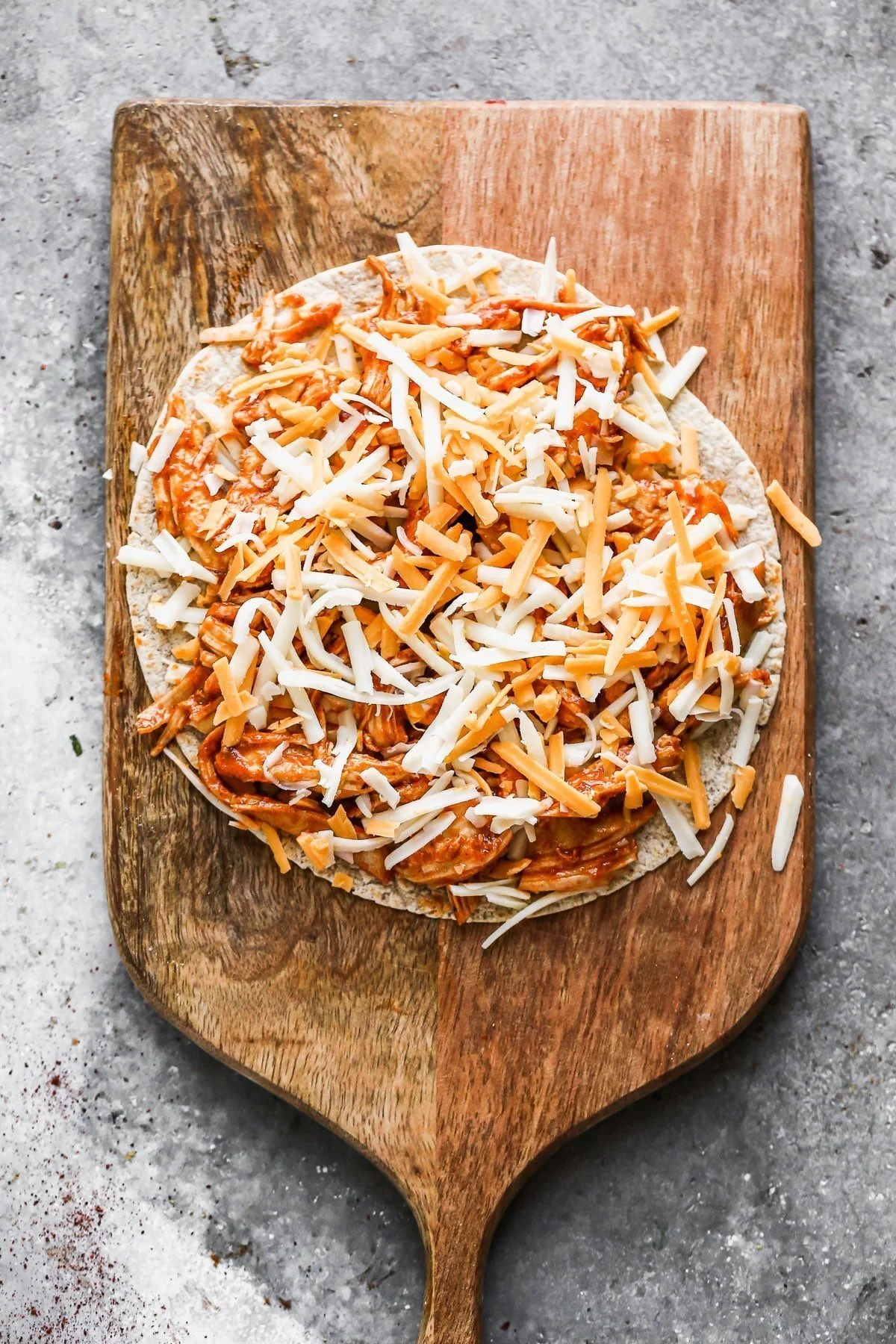 Add chicken to tortillas and sprinkle with cheese.
