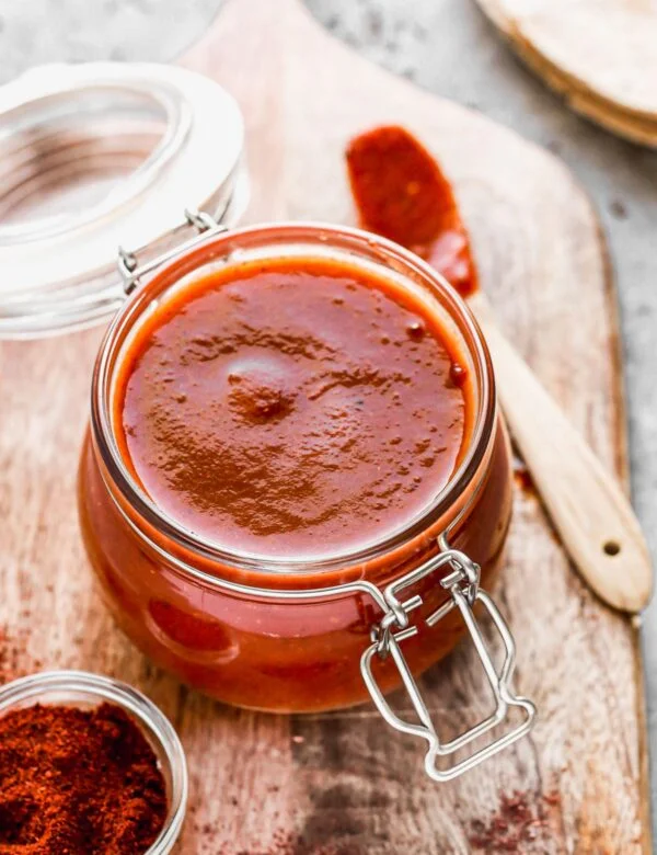 With just a few staple pantry ingredients and 15 minutes of your time, you can whip up an Enchilada Sauce Recipe infinitely better than anything you'll find at the grocery store. Our version is tangy, smoky, and slightly sweet with just a touch of heat. Perfect on enchiladas, tacos, or quick tex-mex inspired pastas.