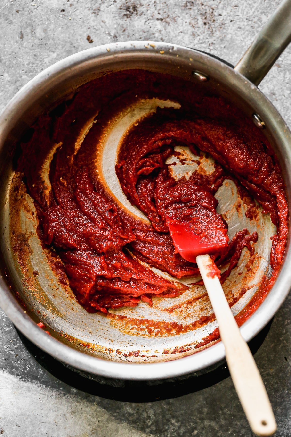 Cook tomato paste with garlic and olive oil.