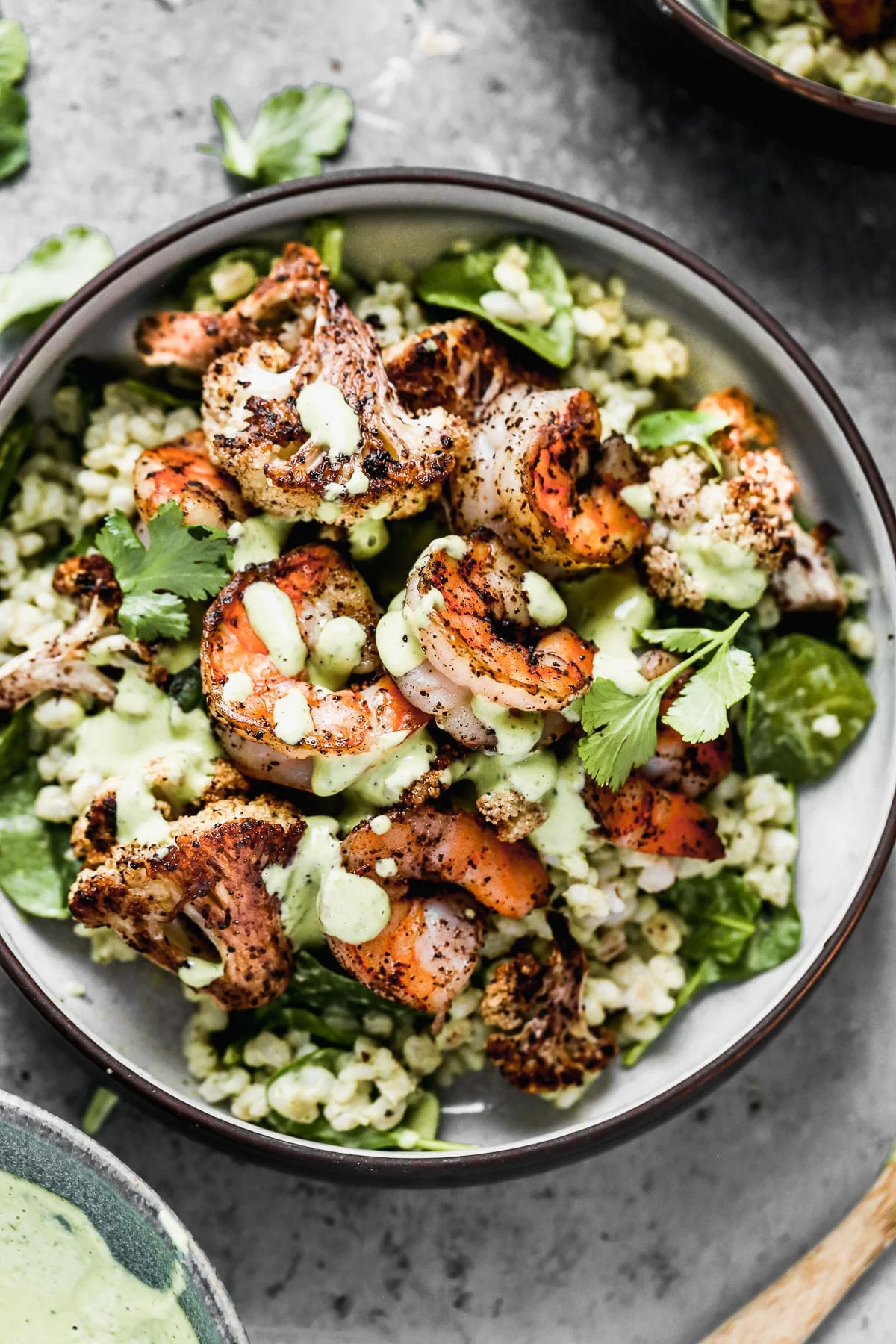 Nutty barley tossed in a zippy green tahini sauce, lemony sumac-roasted cauliflower and shrimp, and pops of crunchy pine nuts are the makings of our Green Tahini Shrimp Bowls - our new favorite way to do healthy. Make everything and serve the day of or pack it up and keep in the fridge to serve thought the week.&nbsp;