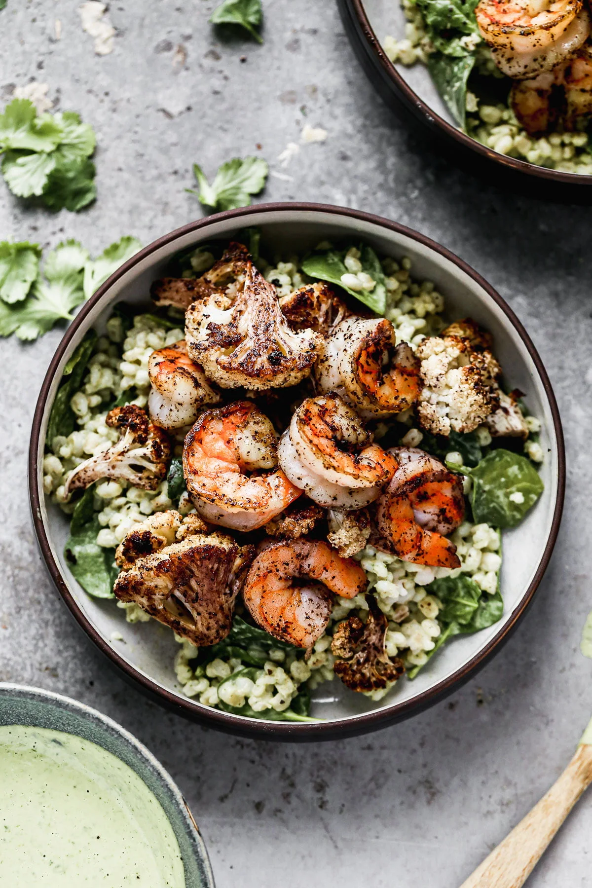 Nutty barley tossed in a zippy green tahini sauce, lemony sumac-roasted cauliflower and shrimp, and pops of crunchy pine nuts are the makings of our Green Tahini Shrimp Bowls - our new favorite way to do healthy. Make everything and serve the day of or pack it up and keep in the fridge to serve thought the week. 