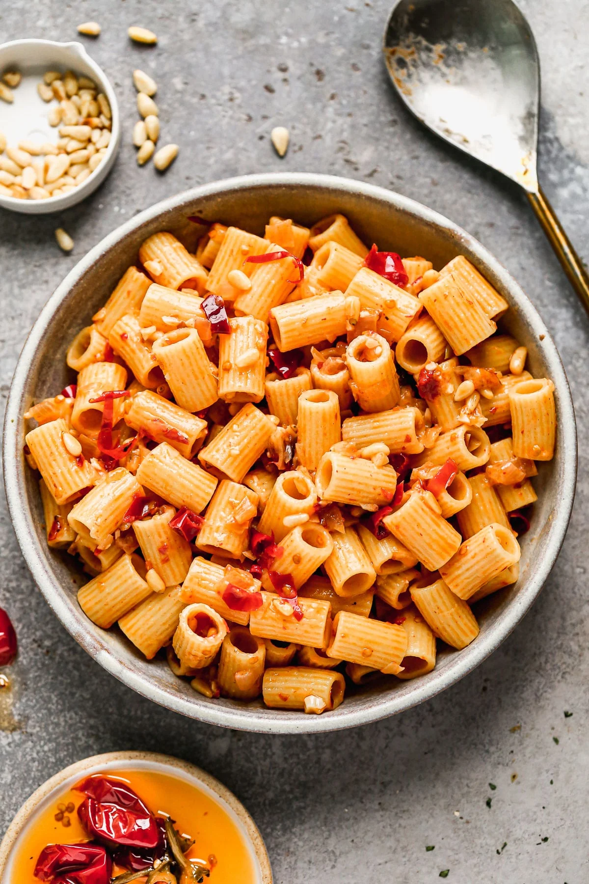 Calabrian Chili Pasta. Fiercely spicy, creamy (without the addition of any cream), cheesy, and peppered with hidden bits of crunch and texture from tiny pine nut treasures. 