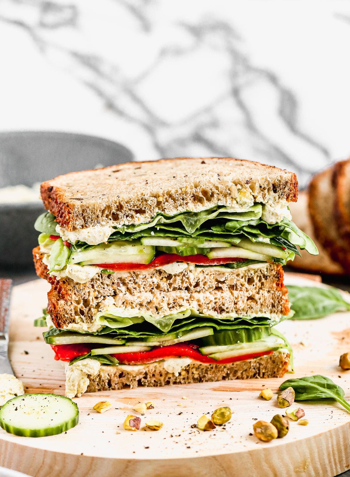 Our take on a classic Cucumber Sandwich includes layers of hearty spinach, vinaigrette-dressed butter lettuce, smoky roasted red peppers, and the pièce de résistance, a pistachio-infused goat cheese that will make you weak in the knees. The perfect lunch to prep early and enjoy all week long. 