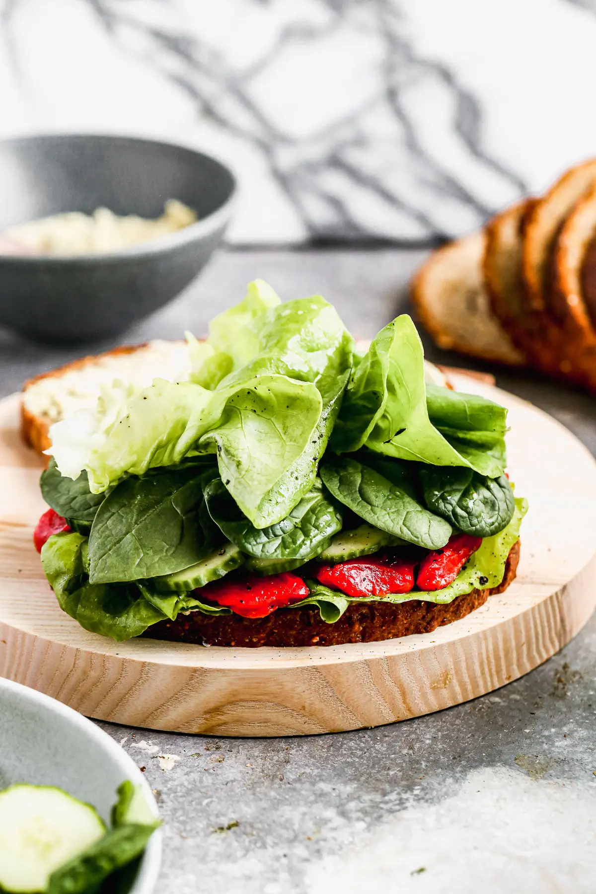 Our take on a classic Cucumber Sandwich includes layers of hearty spinach, vinaigrette-dressed butter lettuce, smoky roasted red peppers, and the pièce de résistance, a pistachio-infused goat cheese that will make you weak in the knees. The perfect lunch to prep early and enjoy all week long.&nbsp;
